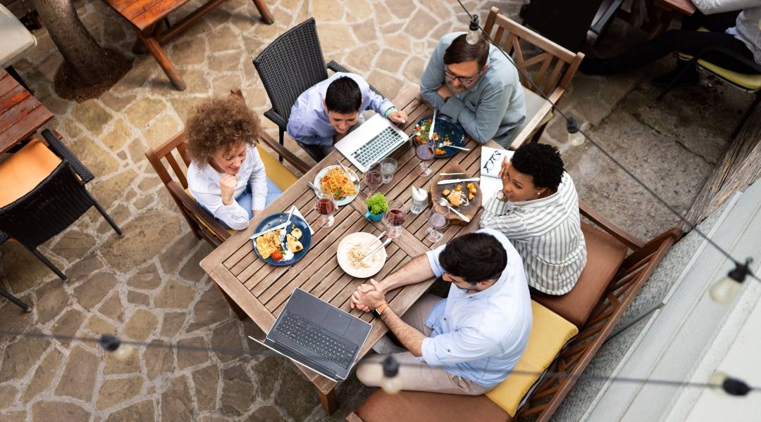 People sitting on a table having lunch and a meeting
